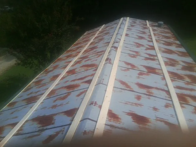 Rusted metal roof panels with new wood purlins before replacement — Storm Damage Roof Repair in Butler by Roofing Brothers